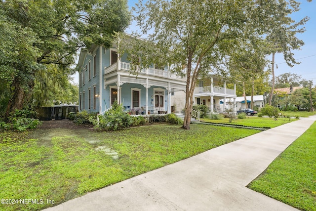 view of front facade with a front yard and a porch