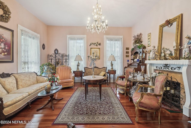 living room featuring an inviting chandelier, plenty of natural light, and dark hardwood / wood-style flooring