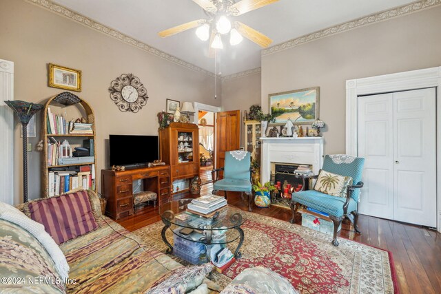 living room with ornamental molding, ceiling fan, and hardwood / wood-style flooring