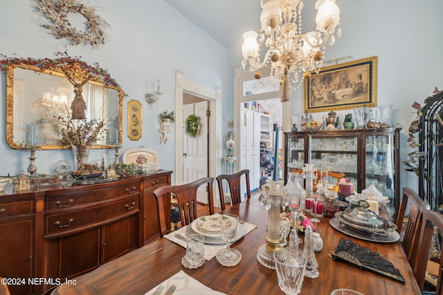 dining space featuring hardwood / wood-style floors and a notable chandelier