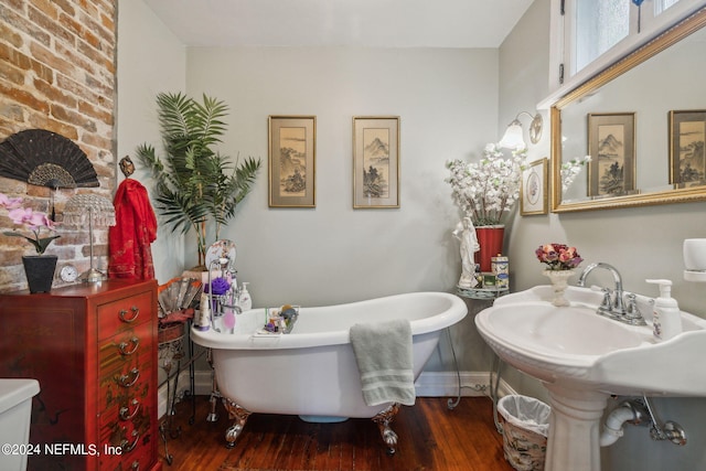 bathroom featuring wood-type flooring and a tub