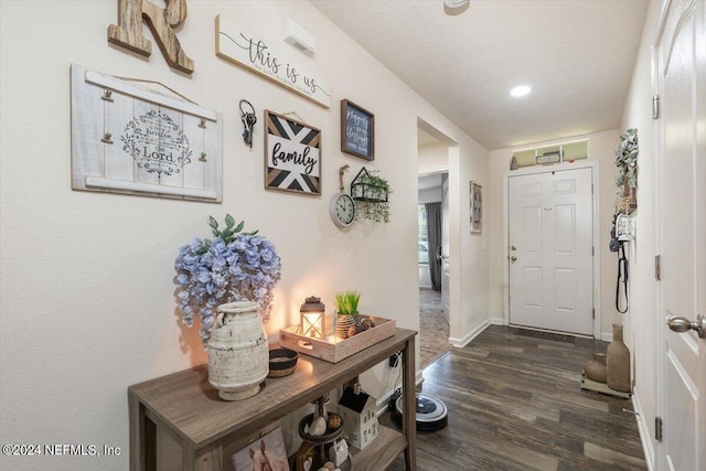 entrance foyer featuring a textured ceiling and dark hardwood / wood-style flooring