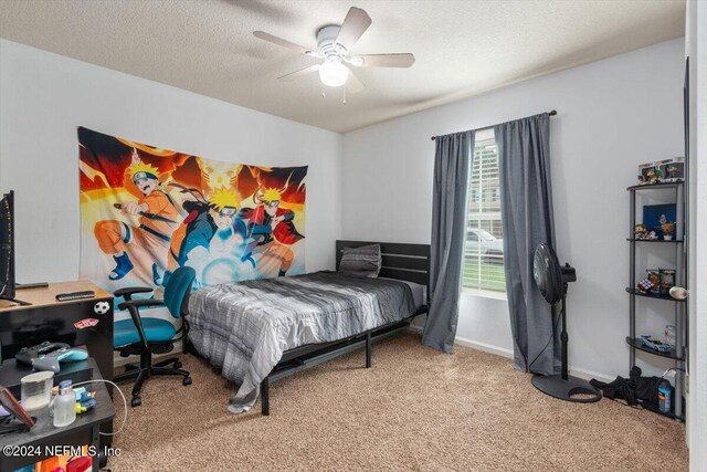 bedroom featuring a textured ceiling, carpet flooring, and ceiling fan