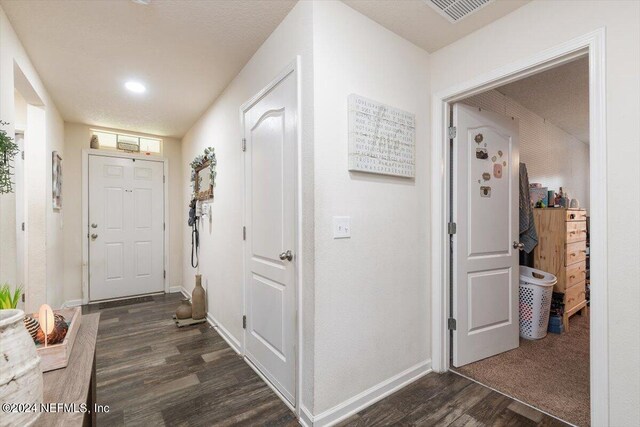 interior space featuring a textured ceiling and dark hardwood / wood-style floors