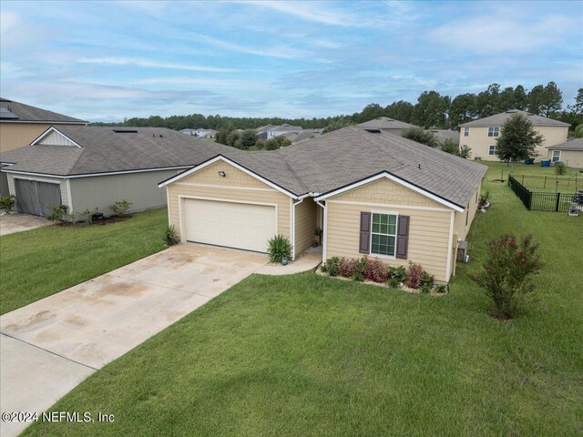 ranch-style house with a front yard and a garage