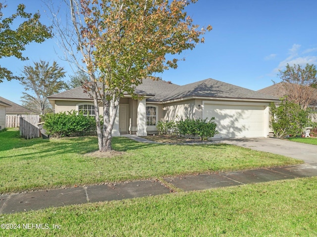 view of front of house with a front yard and a garage