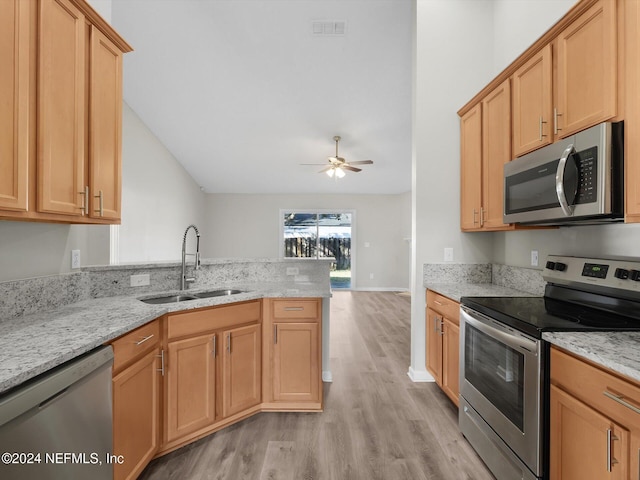 kitchen featuring ceiling fan, sink, stainless steel appliances, light hardwood / wood-style flooring, and kitchen peninsula