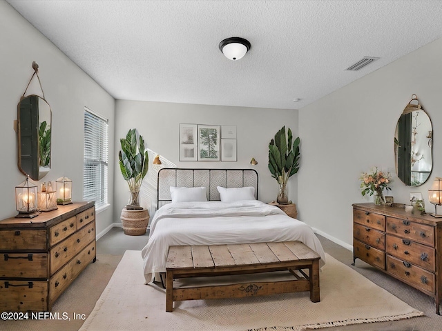 carpeted bedroom with a textured ceiling