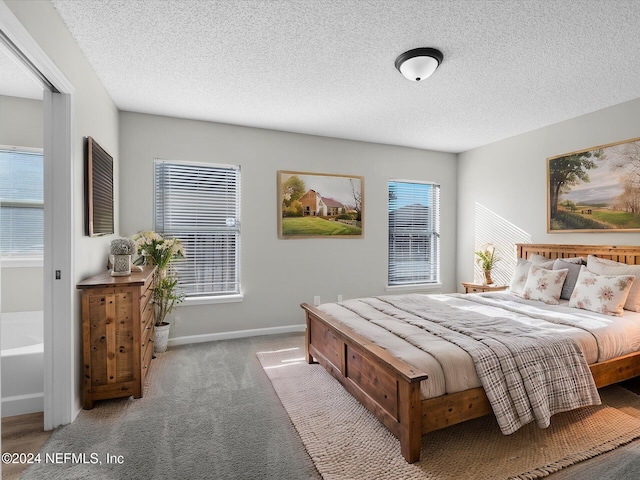 bedroom with light carpet and a textured ceiling