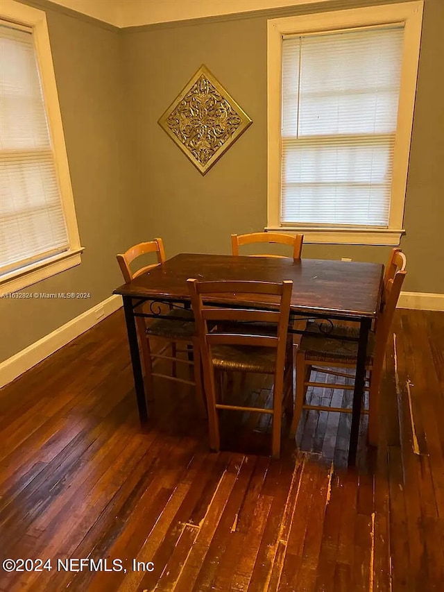 dining area with dark hardwood / wood-style flooring