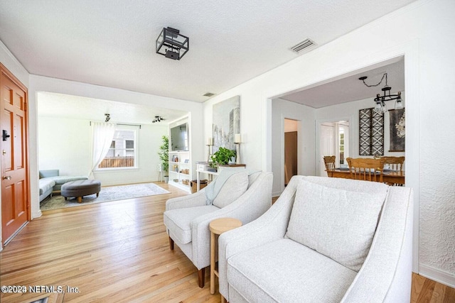 living room with a textured ceiling and hardwood / wood-style flooring