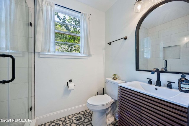 bathroom with tile patterned flooring, vanity, toilet, and a shower with door