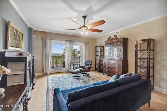 living room with light hardwood / wood-style flooring, ceiling fan, and ornamental molding