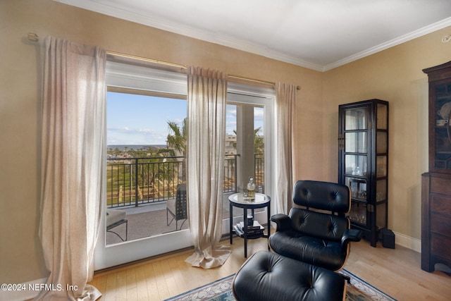 sitting room featuring crown molding and hardwood / wood-style floors