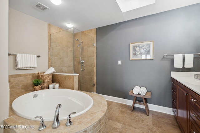 bathroom featuring tile patterned floors, vanity, and shower with separate bathtub