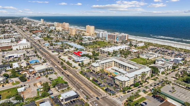 aerial view with a water view and a beach view