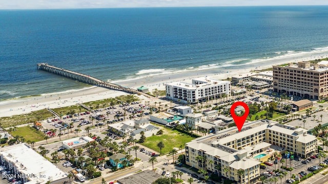 bird's eye view featuring a water view and a beach view