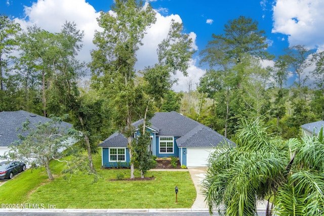 view of front of property featuring a garage and a front lawn