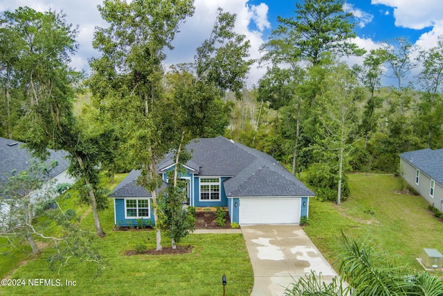 view of front facade with a front yard and a garage