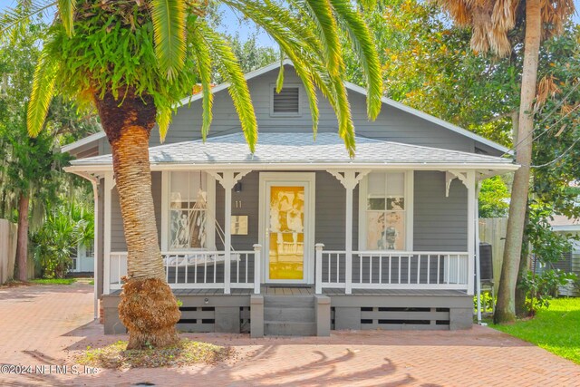 view of front of house with central AC and a porch