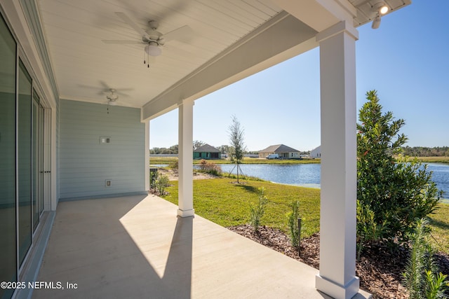 view of patio featuring ceiling fan and a water view