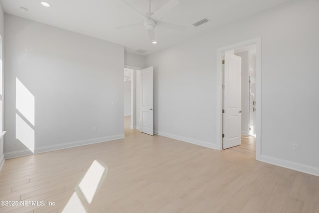 spare room featuring light wood-type flooring and ceiling fan