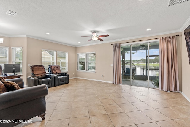 living room with ornamental molding, ceiling fan, light tile patterned floors, and a textured ceiling