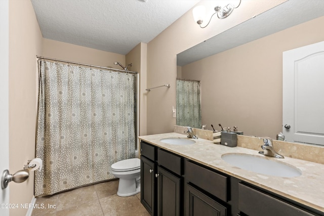 bathroom featuring vanity, a textured ceiling, tile patterned flooring, toilet, and a shower with curtain