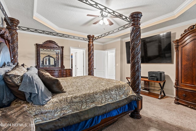 carpeted bedroom with a textured ceiling, ceiling fan, a raised ceiling, and crown molding