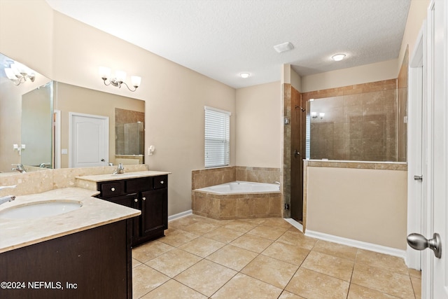 bathroom with vanity, shower with separate bathtub, a textured ceiling, and tile patterned floors