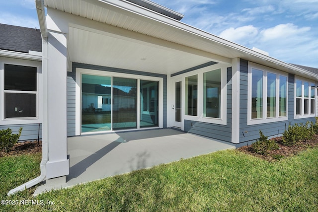 back of property with a patio and a yard