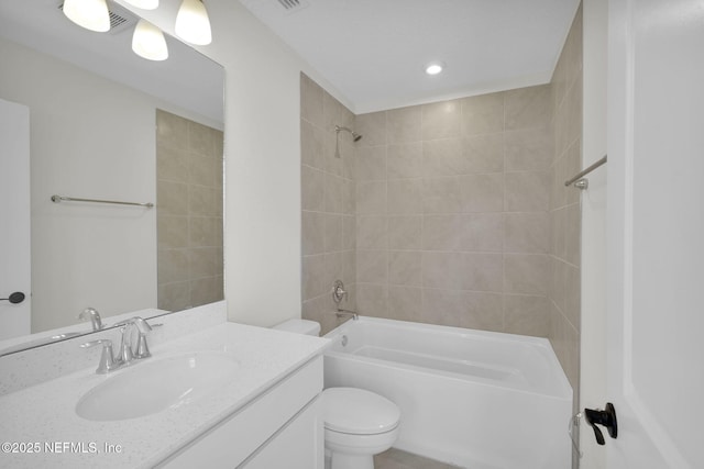 full bathroom with vanity, toilet, and tiled shower / bath combo