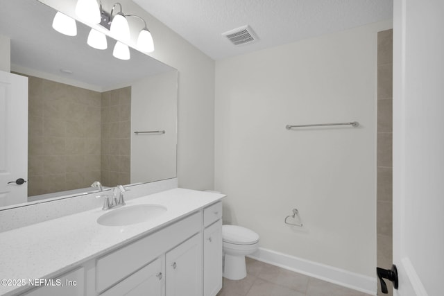 bathroom with vanity, tile patterned floors, a textured ceiling, and toilet