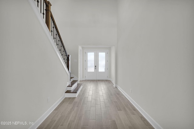 entryway with light hardwood / wood-style flooring and french doors