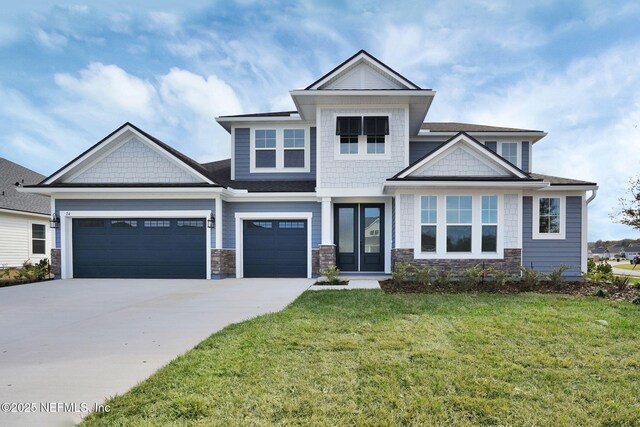 craftsman-style house featuring a garage and a front lawn