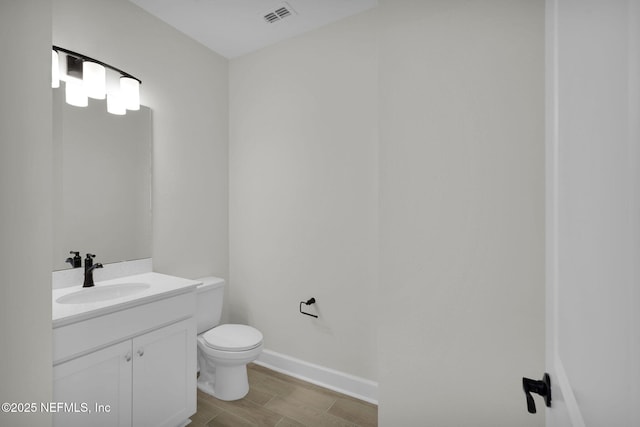 bathroom featuring hardwood / wood-style flooring, vanity, and toilet