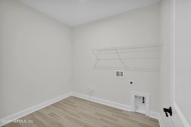 clothes washing area with hookup for a washing machine, electric dryer hookup, and light wood-type flooring