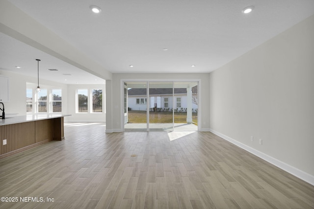 unfurnished living room featuring light wood-type flooring