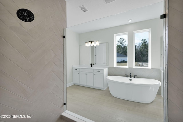 bathroom featuring vanity and shower with separate bathtub