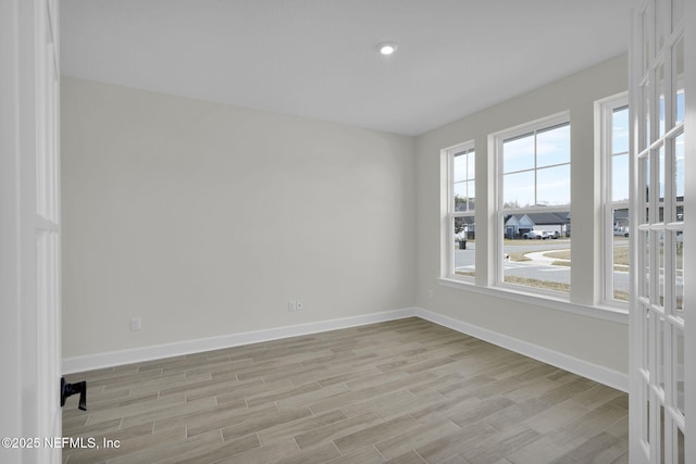 spare room with light hardwood / wood-style floors