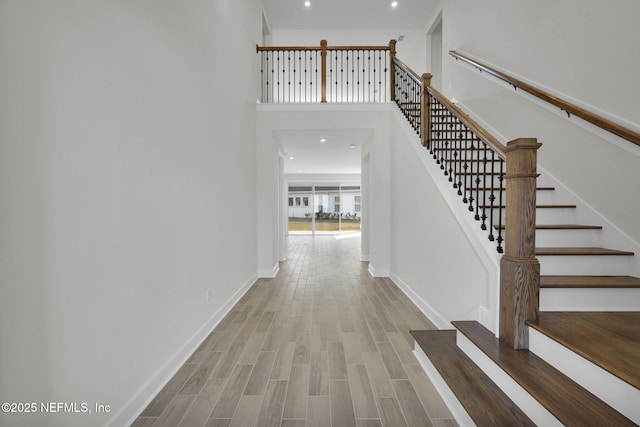 interior space with wood-type flooring and a high ceiling