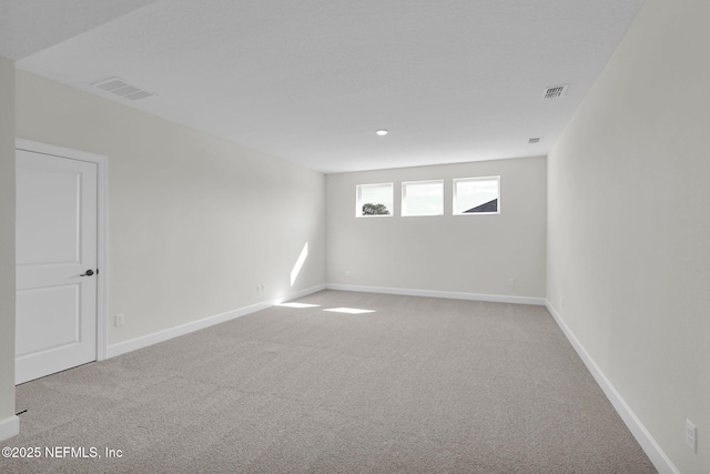 unfurnished room featuring carpet flooring