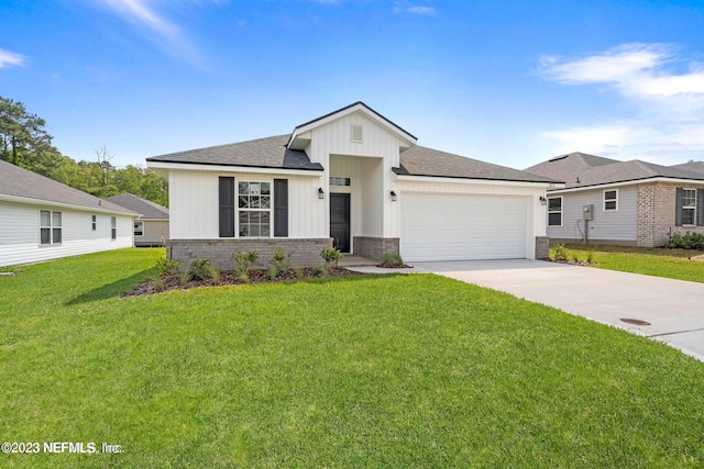 view of front of house featuring a front yard and a garage