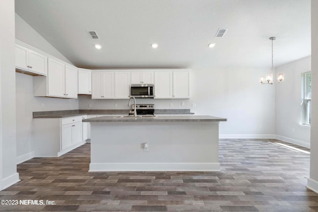 kitchen featuring a center island with sink, vaulted ceiling, dark hardwood / wood-style flooring, and white cabinets