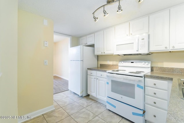 kitchen featuring white cabinetry, white appliances, a textured ceiling, and light tile patterned flooring