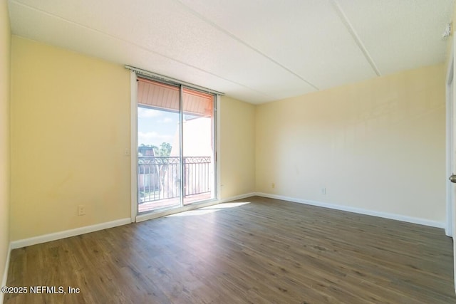 spare room with dark hardwood / wood-style flooring