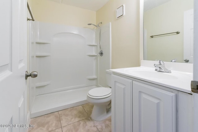 bathroom featuring a shower, toilet, vanity, and tile patterned flooring