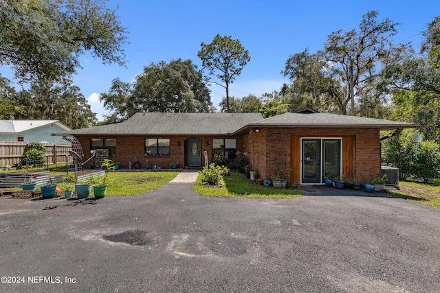 single story home with cooling unit