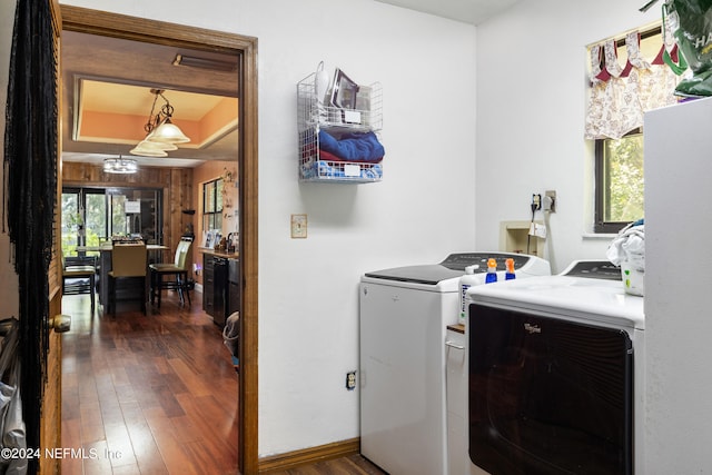 washroom with dark hardwood / wood-style flooring and washer and dryer