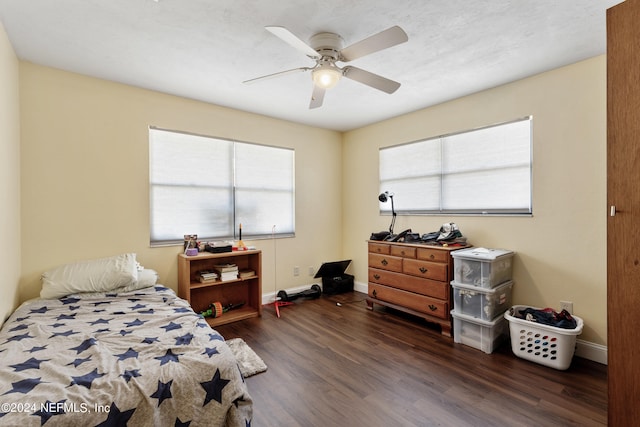 bedroom with dark hardwood / wood-style flooring, multiple windows, and ceiling fan